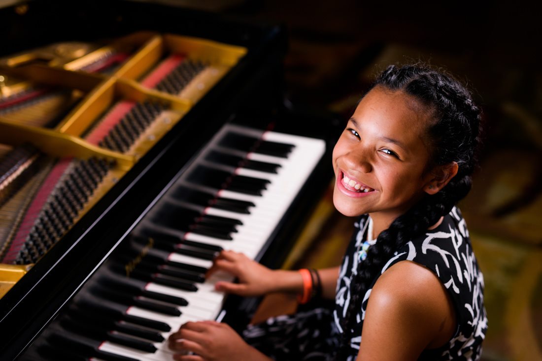 smiley girl at grand piano